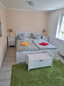 a bedroom with two beds and a green rug at Ferienwohnung Ribnitz-Damgarten in Ribnitz-Damgarten