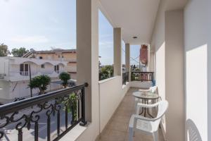 a balcony with a table and chairs on it at Kostas 2 in Kos