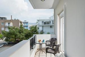 a balcony with a table and chairs and a view at Kostas 2 in Kos
