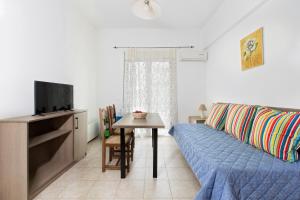 a living room with a couch and a table at Kostas 2 in Kos