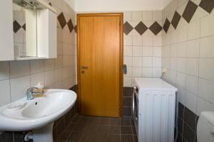 a bathroom with a sink and a wooden door at Kostas 2 in Kos +53 photos