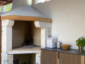 a brick oven with a microwave on top of it at Apartmani Perić in Stari Grad