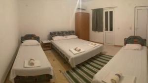 a room with three beds in a room at Apartmans sabovic in Ulcinj