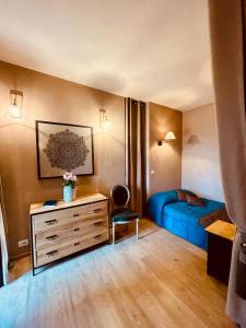 a bedroom with a bed and a dresser with a desk at Suite Villa Aurelj in Barolo