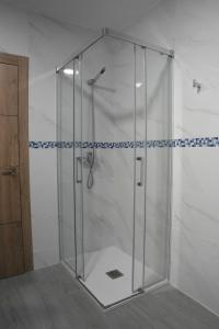 a shower with a glass door in a bathroom at Mediterraneo in Faro de Cullera