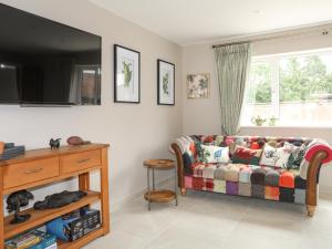 a living room with a couch and a window at Cascon in St Asaph