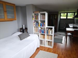 a bedroom with a white book shelf filled with books at Chalet en Quintueles afueras de Gijón Asturias in Quintueles +27 photos