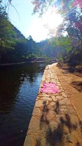 a pink shirt laying on the side of a river at La Portilla de Cabezo in Cabezo