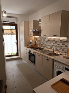 a kitchen with a sink and a stove top oven at La casa in piazzetta in Enna