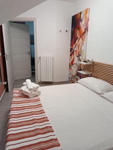 a bedroom with a large bed with a rug on the floor at La casa in piazzetta in Enna