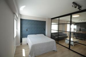 a bedroom with a bed and a living room at Espectacular loft lleno de luz y espacio! in Zaragoza