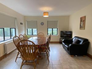 a living room with a table and chairs and a couch at Cottage 442 - Oughterard in Oughterard