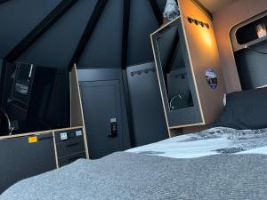 a bedroom with a bed and two mirrors on the wall at Vikajärvi Lake View Experience Igloos in Rovaniemi