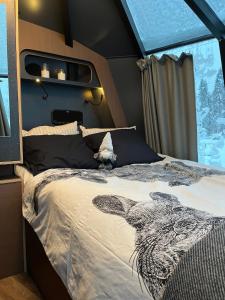 a bedroom with a bed with a zebra on it at Vikajärvi Lake View Experience Igloos in Rovaniemi