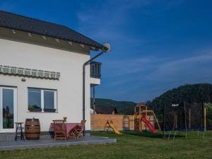 a house with a yard with a playground at DOM HILLS Bucovina in Gura Humorului