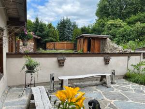 a patio with two benches and a wooden fence at Ubytování Elias in Černá v Pošumaví