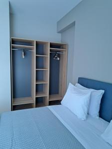 a bedroom with a blue bed and some shelves at Christine luxury villa in Kolymvari