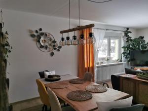 a dining room with a wooden table with chairs at Apartment nähe Red Bull Ring in Kobenz