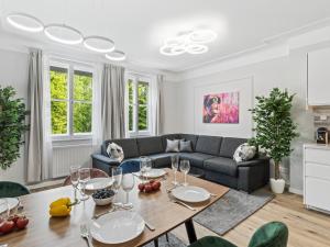 a living room with a table and a couch at SKY9 Apartments Schönbrunn Palace in Vienna