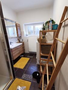 a small bathroom with a staircase and a sink at Apartment nähe Red Bull Ring in Kobenz