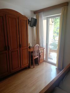 a bedroom with a desk and a sliding glass door at Villa Luka in Brela