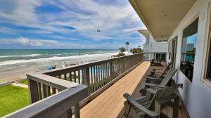 a balcony of a house with a view of the beach at Driftwood Beach Motel in Ormond Beach