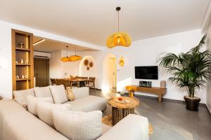 a living room with a couch and a table at Villa Nous luxury in Skala Sotiros