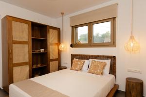 a bedroom with a bed and a window at Villa Nous luxury in Skala Sotiros +50 photos