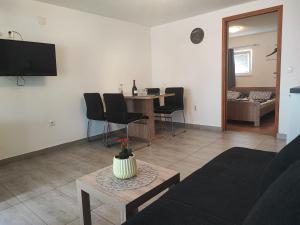 a living room with a couch and a table at Apartman Luka in Vodice