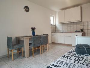 a kitchen with a table and chairs in a room at Apartman Luka in Vodice