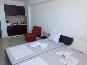 a bedroom with a bed with towels on it at Guest House Kolev 2 in Sunny Beach