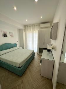a bedroom with a bed and a television in it at Ametista Rooms Tropea in Tropea