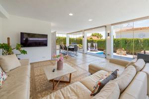 a living room with a couch and a tv at Ferienhaus Casa Kristel in Badia Gran