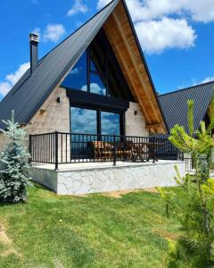 a house with a large roof with a deck at WOLFOREST in Žabljak