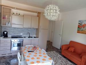 a small kitchen with a table and a couch at Relax in valle in Martina Franca