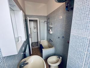 a bathroom with a sink and a toilet and a tub at Blue Milano in Milan