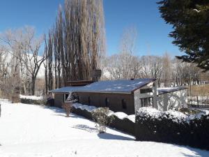 a house with snow on the ground in a yard at Aires de Uspallata in Uspallata