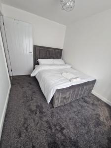 1 dormitorio con 1 cama grande con sábanas blancas en Serenity Space Luxury Home 3 Bed House Near Bluewater en Kent