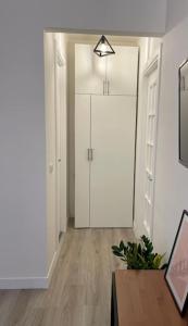 a room with a hallway with a closet and a table at Colosseo Living Suites in Rome