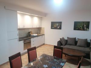 uma cozinha e uma sala de estar com um sofá e uma mesa em Villa Amfora em Lipci