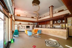 a kitchen and dining room with colorful chairs and a counter at Kuzey Park Hotel in Gokceada Town