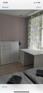 a room with a kitchen with a desk and a window at Mega widok 6 in Szklarska Poręba