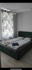 a large bed in a bedroom with at Mega widok 6 in Szklarska Poręba
