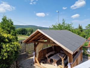 a wooden dog house with a slate roof at Snow Queen in Szklarska Poręba