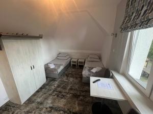 a small room with two beds and a table at HORIZON in Ustka