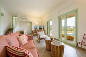 a living room with a couch and a table at Plioni Villas & Suites in Mikri Vigla