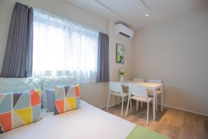 a room with a bed and a table with chairs at The most comfortable and best choice for accommodation in Yoyogi SoS5 in Tokyo