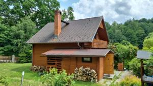 a log cabin with a black roof at Chata Górska Sowa dla 12 osób, 4 sypialnie,salon z kominkiem in Podgórzyn