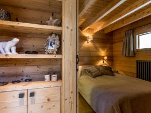 a bedroom with a bed in a wooden cabin at Chalet Val-d'Isère, 5 pièces, 8 personnes - FR-1-694-6 in Val-d'Isère