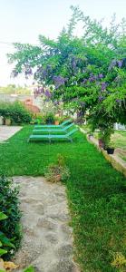 a garden with purple flowers and a tree at Casa Fiore Olbia in Olbia